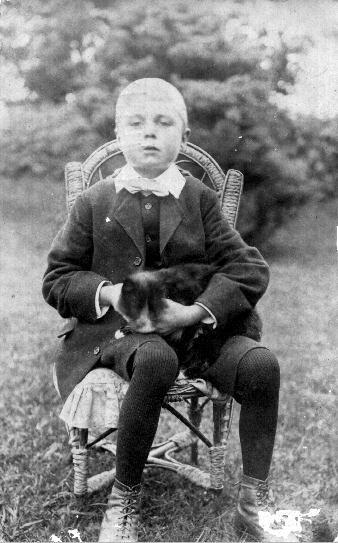 A young WILLIAM FREDERICK IVEY with family pets.